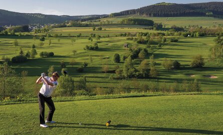 Ein Mann spielt Golf auf dem Golfplatz vom Romantik- und Wellnesshotel Deimann im Sauerland