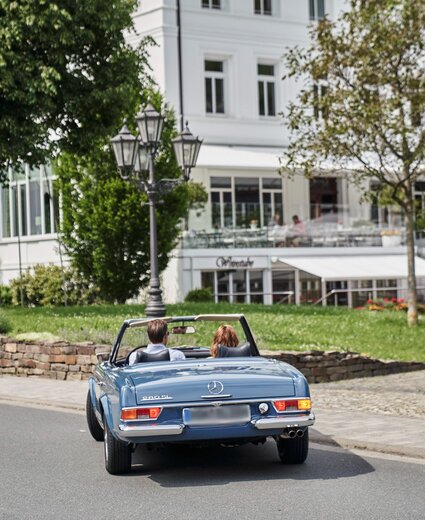 Oldtimer fährt auf den Parkplatz vom Hotel Deimann